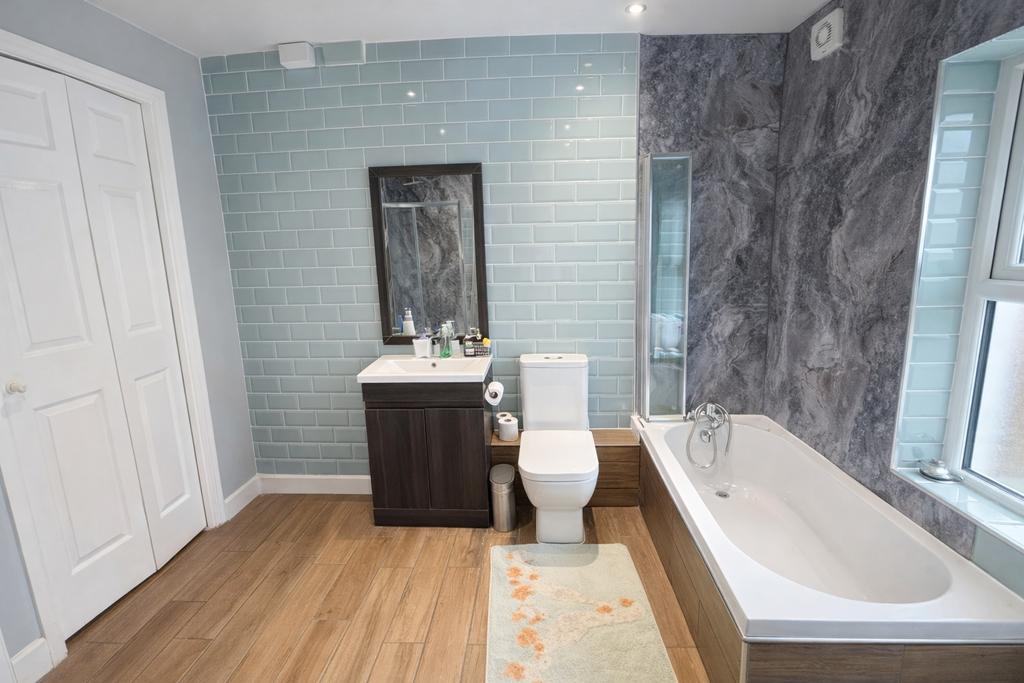Well-appointed bathroom with a fitted bath, mod...