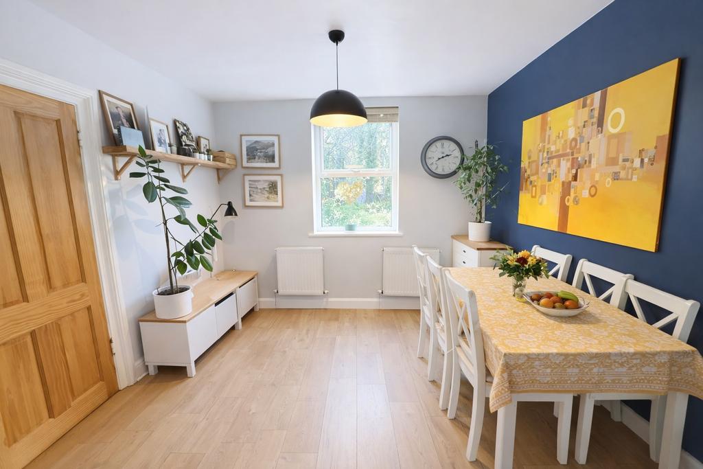 Bright, modern dining room with a large window,...