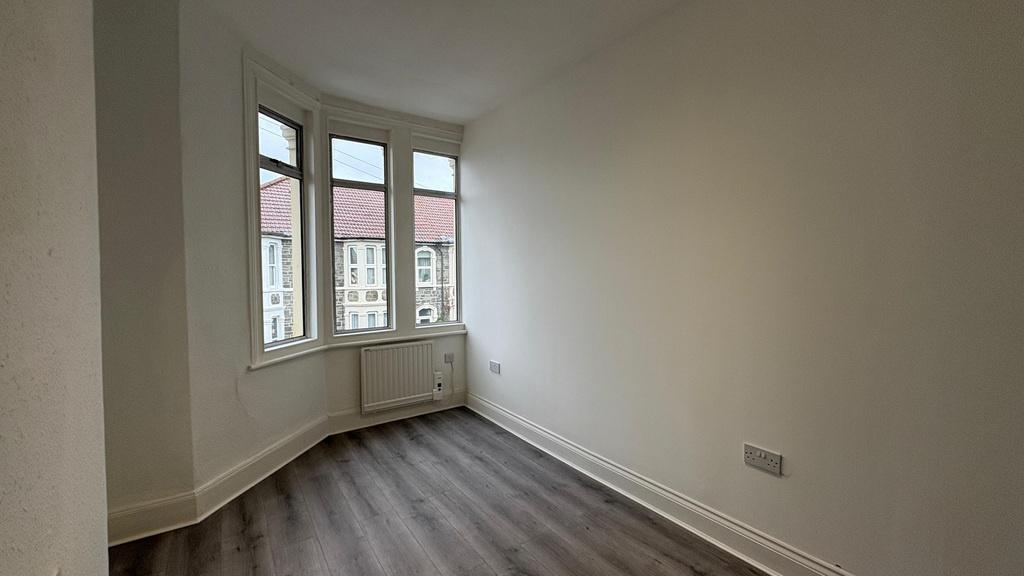 Bright, freshly painted bedroom with a bay wind...