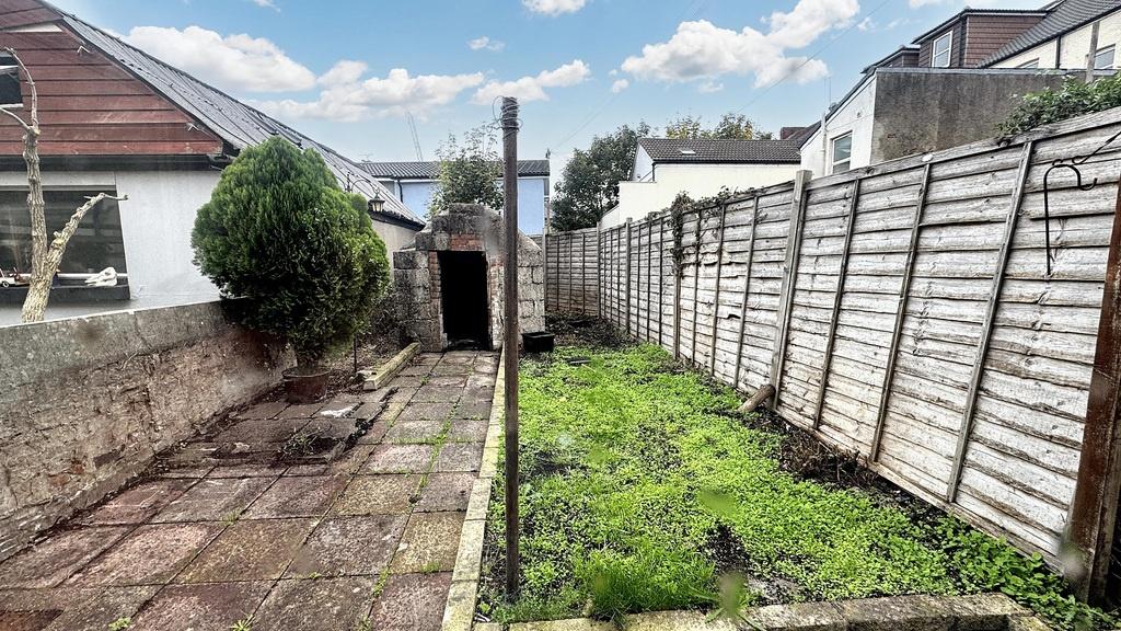 Outdoor rear garden with paved patio area, narr...