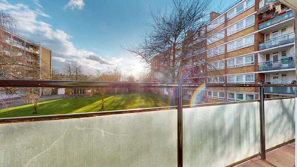 Sunny communal garden viewed from a private bal...