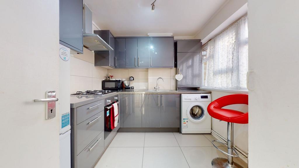 Bright modern kitchen with glossy grey cabinets...
