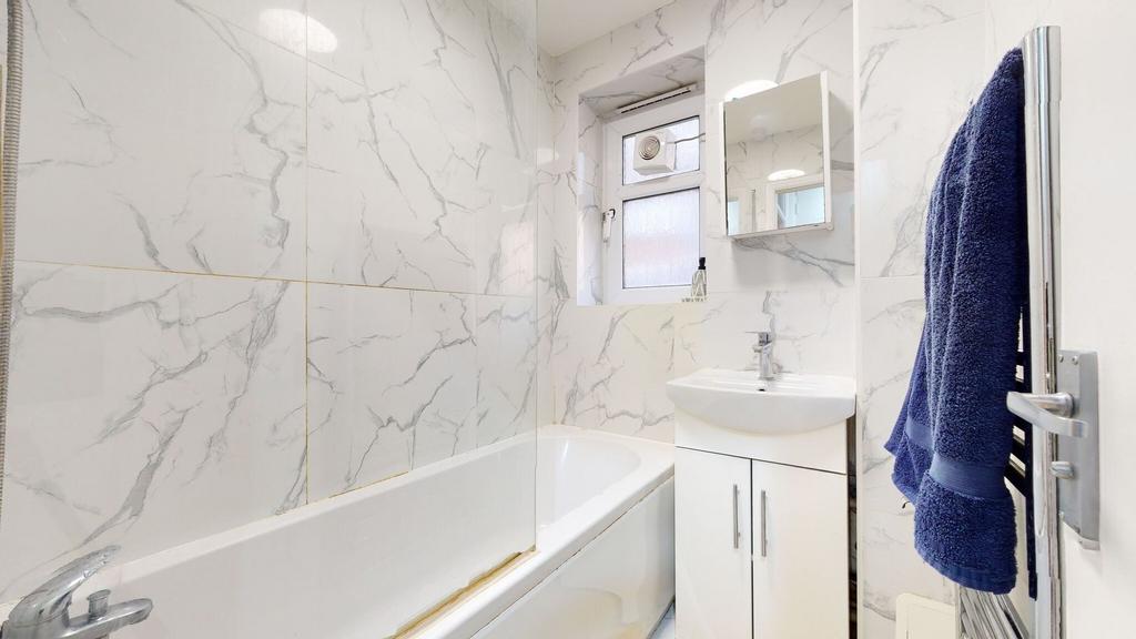 Bright modern bathroom with white marble-effect...