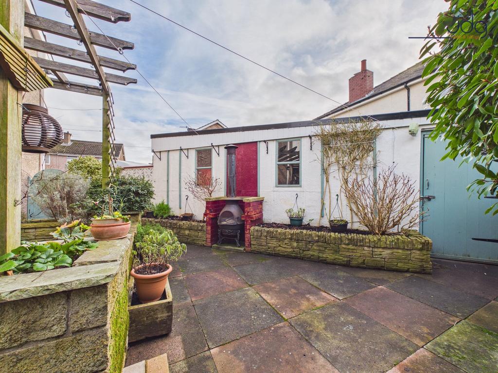 A dedicated BBQ area with side entrance to the...
