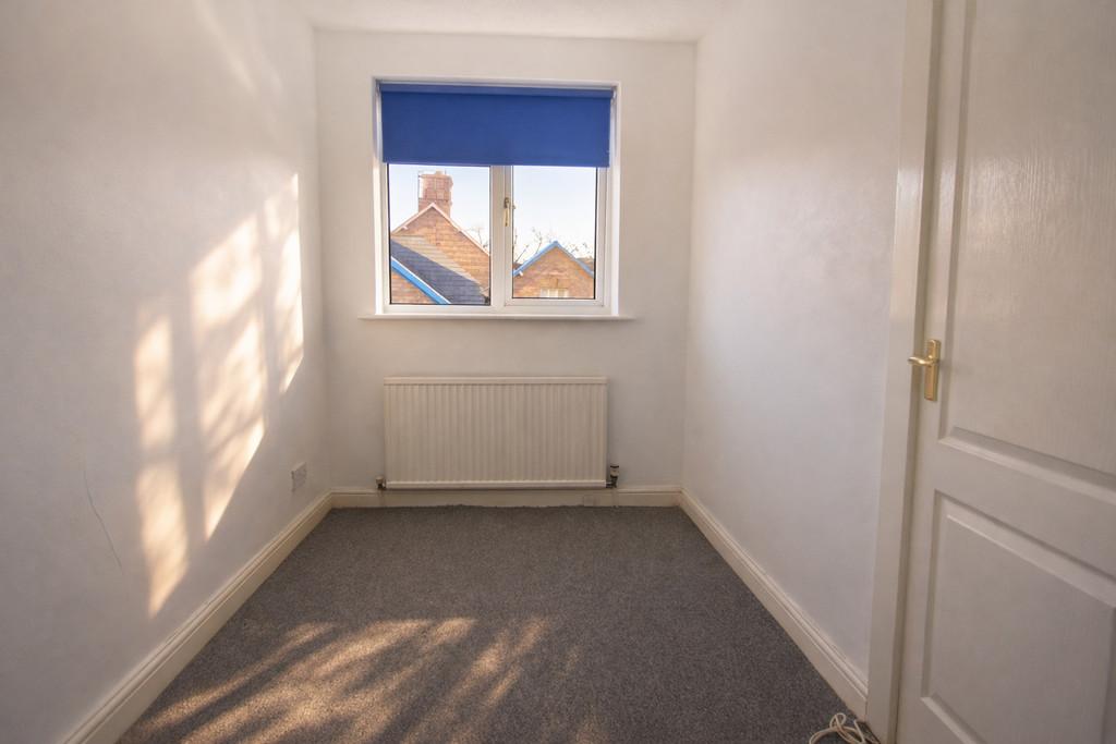 Sunny bedroom with blue roller blind