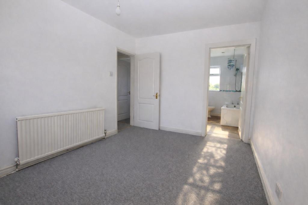 Sunny empty bedroom with open doors