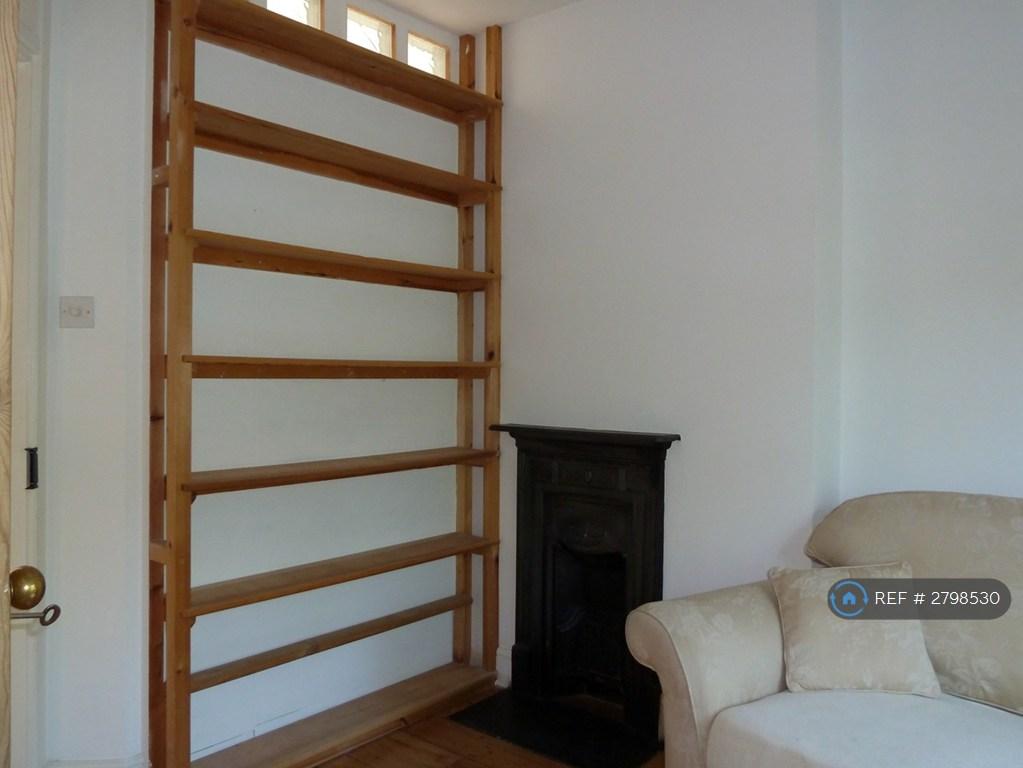 Sitting Room With Fireplace And Bookshelves