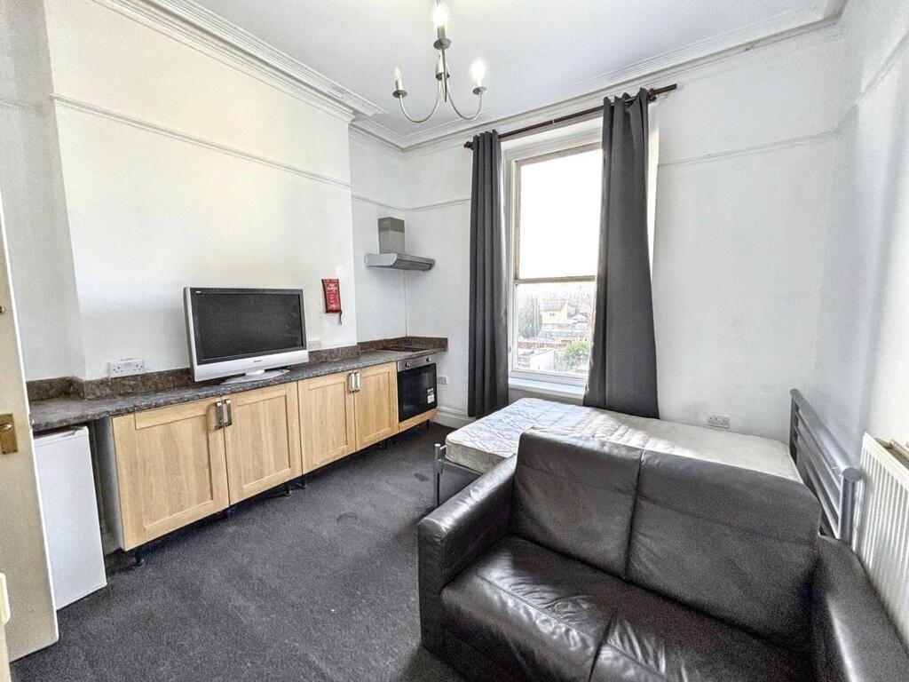 Bright communal lounge with a comfortable leath...