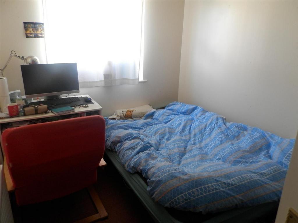 Bright, simply furnished bedroom with a double ...