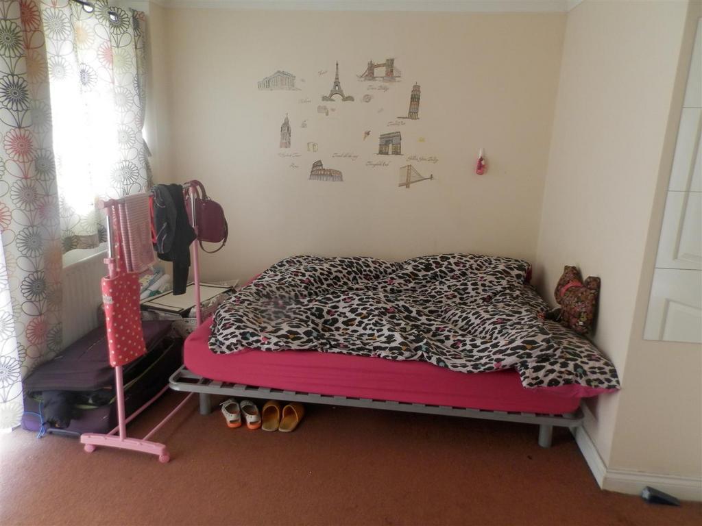 Small furnished bedroom with a single bed, patt...