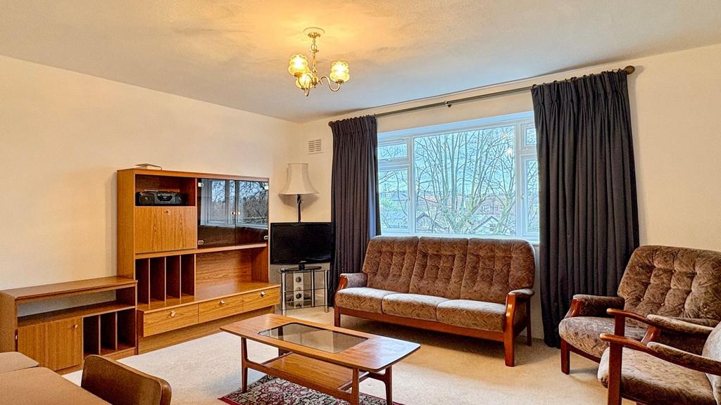 Bright, well-maintained living room with large ...