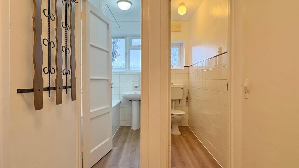 Bright, tiled bathroom area with a separate WC ...