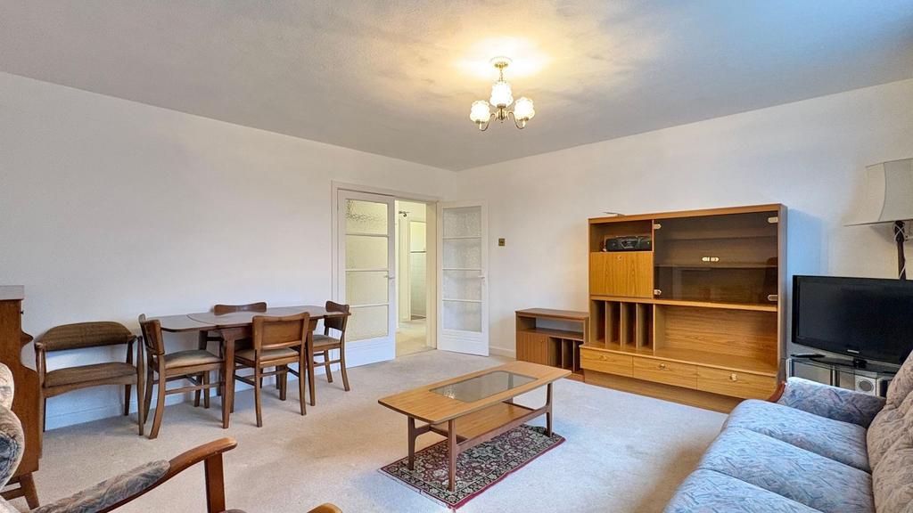Bright, neutrally decorated living room with vi...