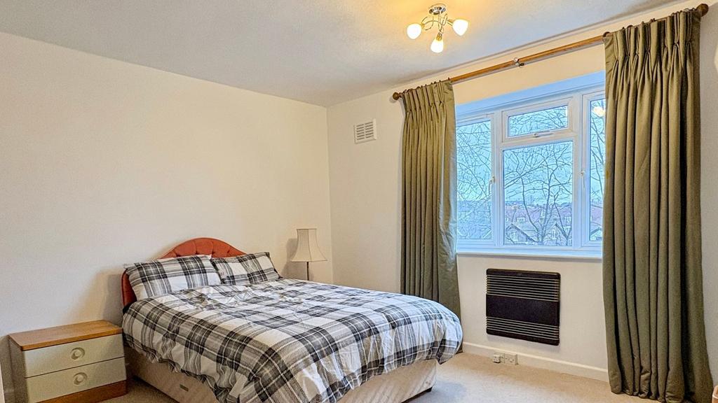Bright, simply decorated double bedroom with la...