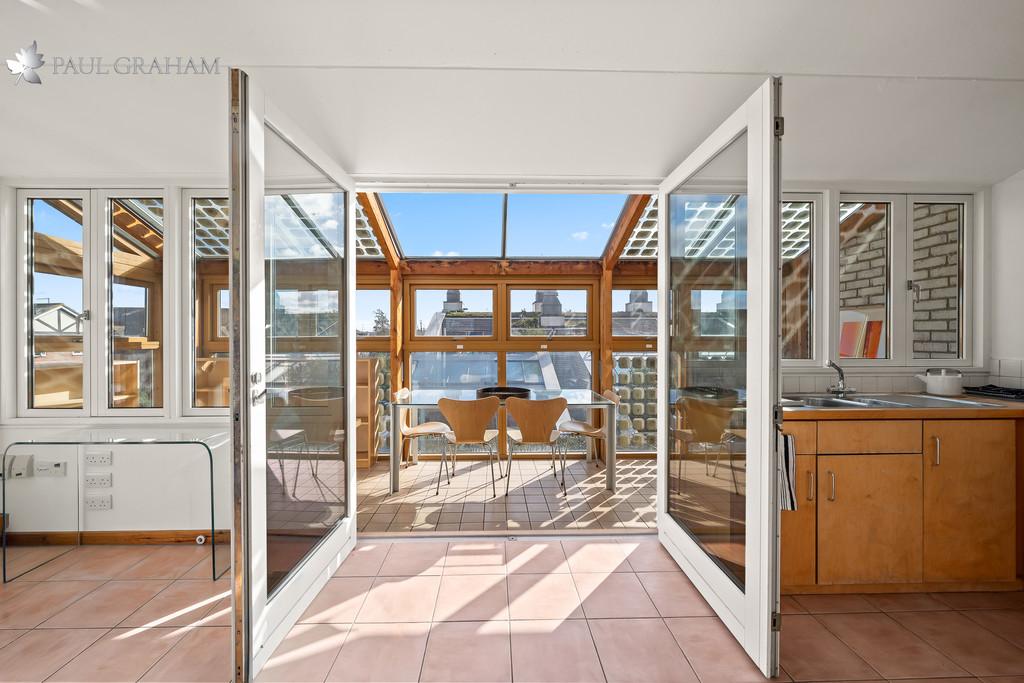 Conservatory interior, french doors leading to garden