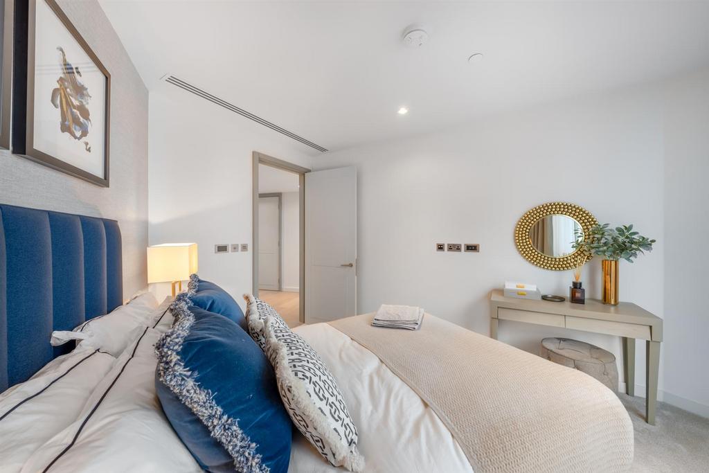 Primary bedroom with large windows and city views