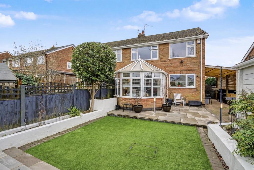 Suburban garden with conservatory and lawn.png