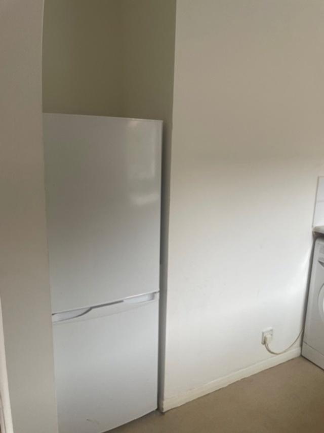 Simple kitchen alcove with a freestanding white...