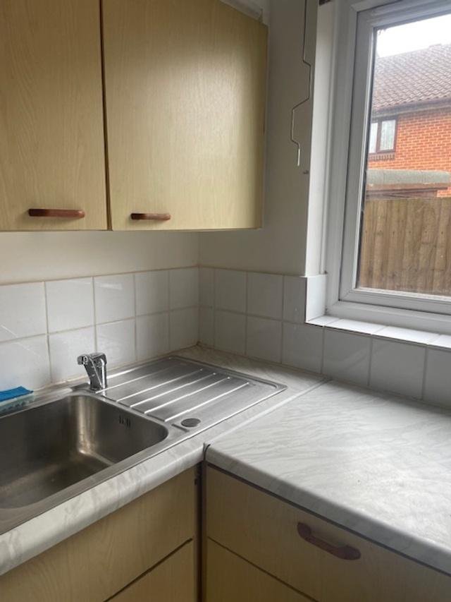 Compact fitted kitchen with stainless-steel sin...