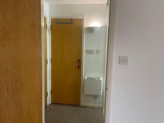 Simple, well-maintained hallway with light wood...