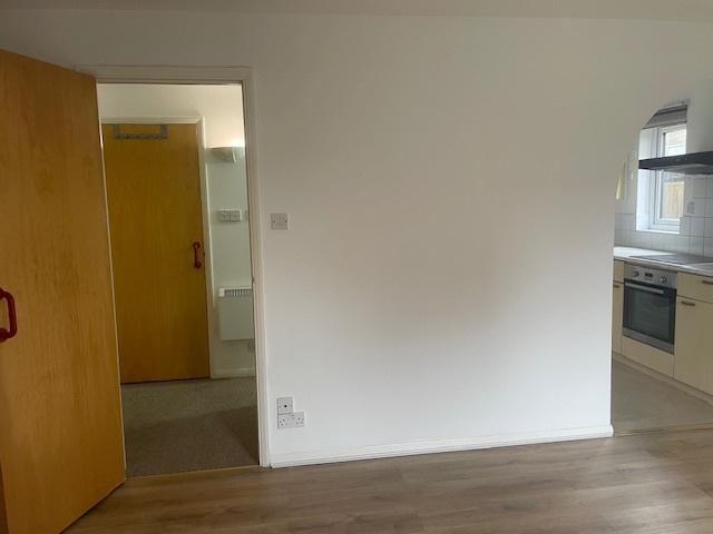 Bright, neutral living area with laminate floor...