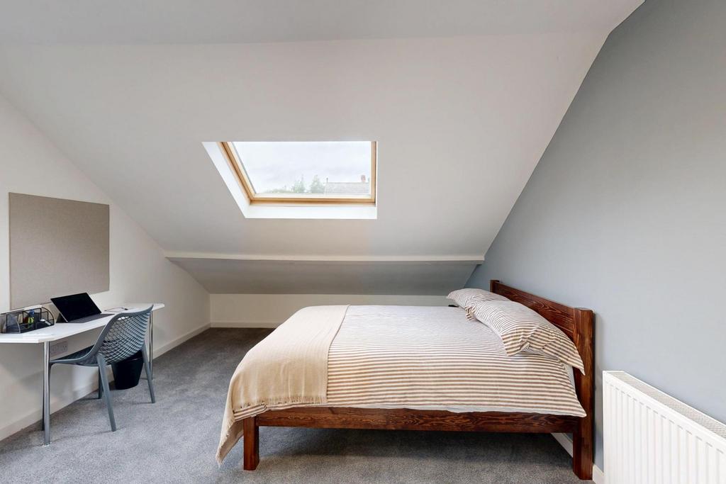A bright and spacious master bedroom featuring ...