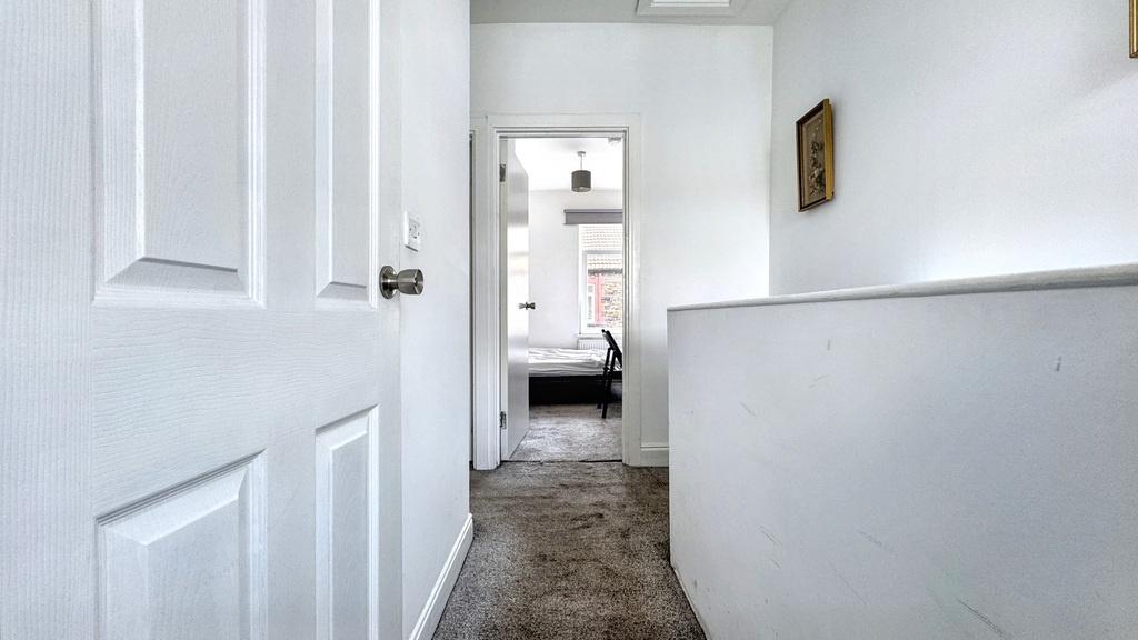 Bright, neutral hallway with clean white walls,...