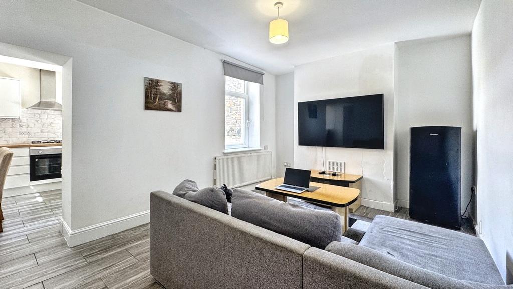 Bright, modern living room with a comfortable g...