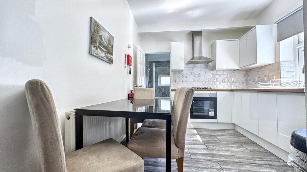 Bright modern kitchen with integrated oven, sta...