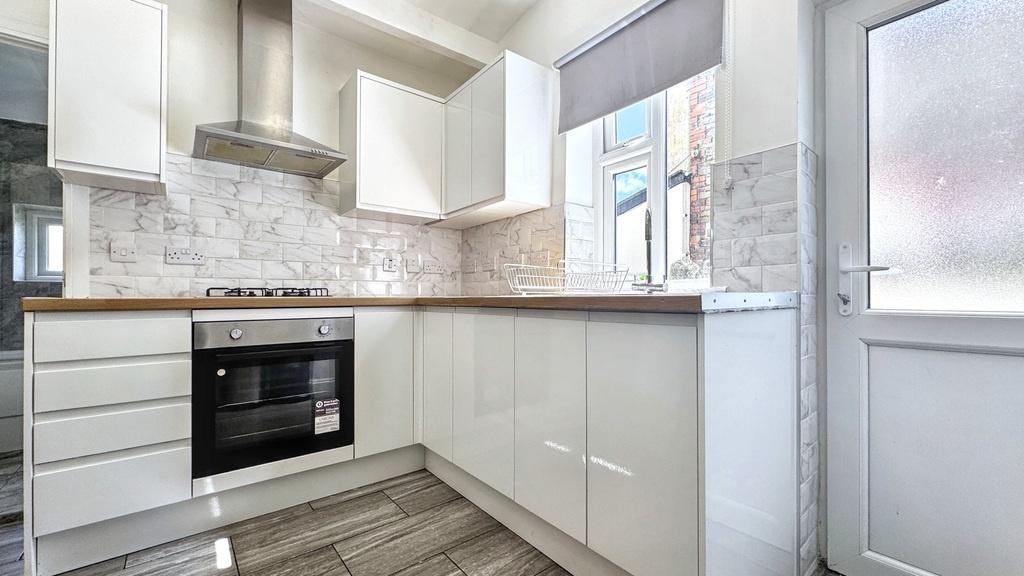 Bright, modern kitchen with gloss white cabinet...