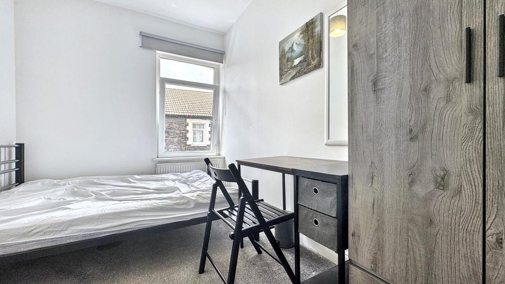 Bright, neatly presented bedroom with a comfort...