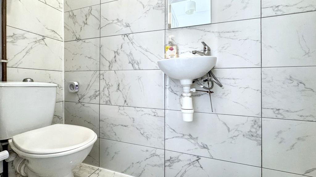 Bright, modern bathroom with marble-effect tile...