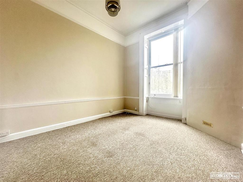 Bright bedroom with large sash window...