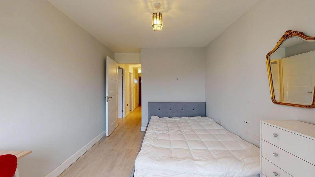 Bright, simply styled bedroom with a comfortabl...