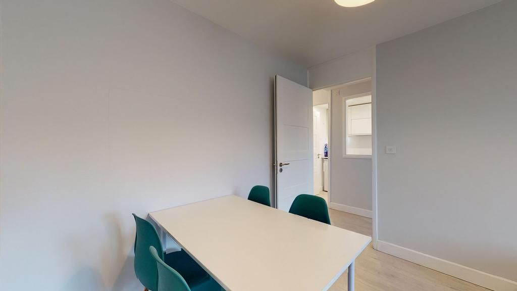 Bright, neutral study area with a large white t...