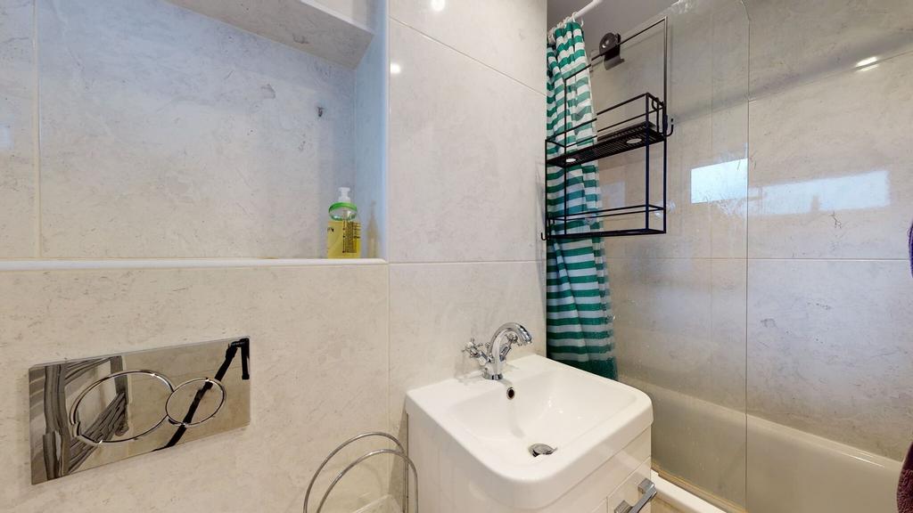 Bright, modern bathroom with a white sink, chro...