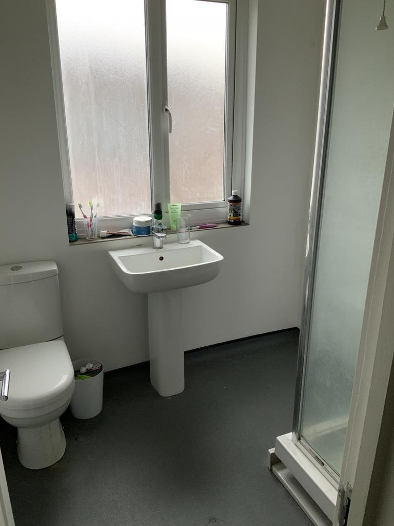 A clean, bright bathroom with a modern sink, to...