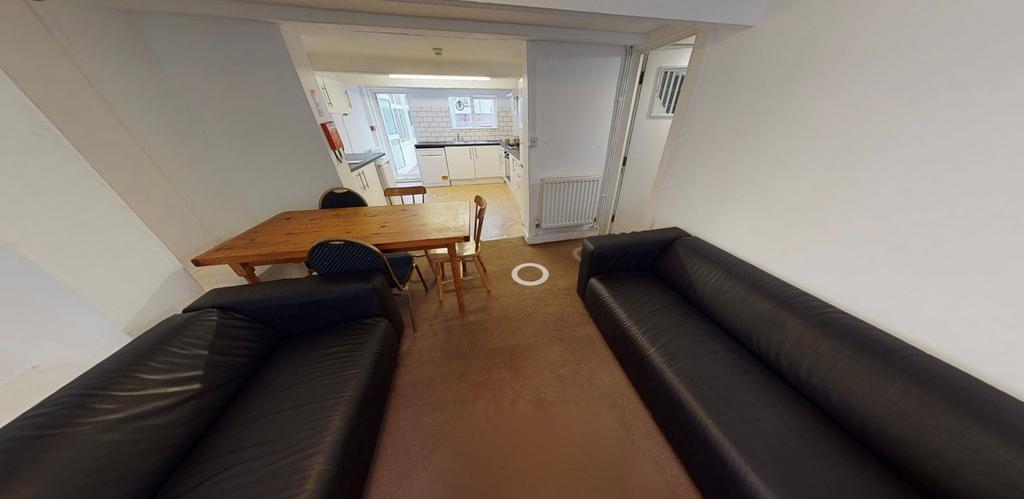 Bright communal lounge with two long sofas faci...