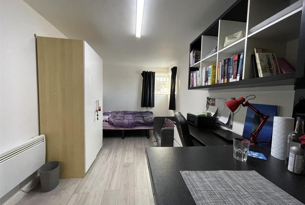 Neat, well-organised single bedroom with a work...