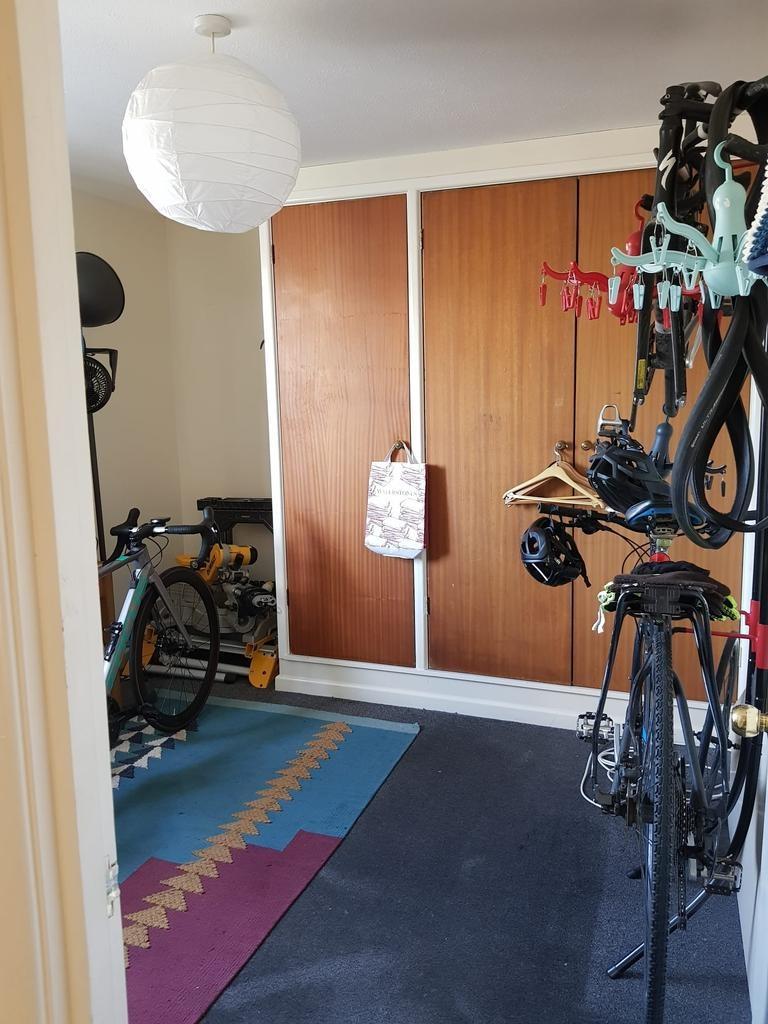 Bright, tidy room with built-in wooden wardrobe...