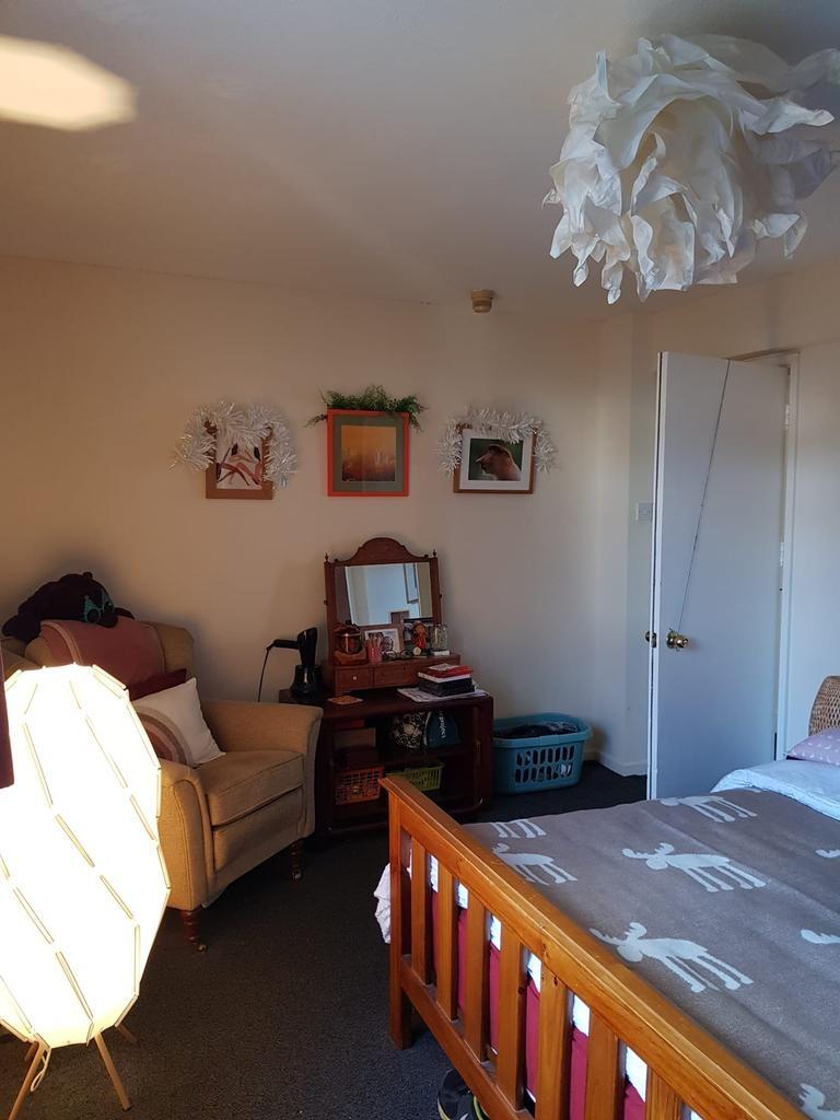 Bright, cosy bedroom with a wooden double bed, ...
