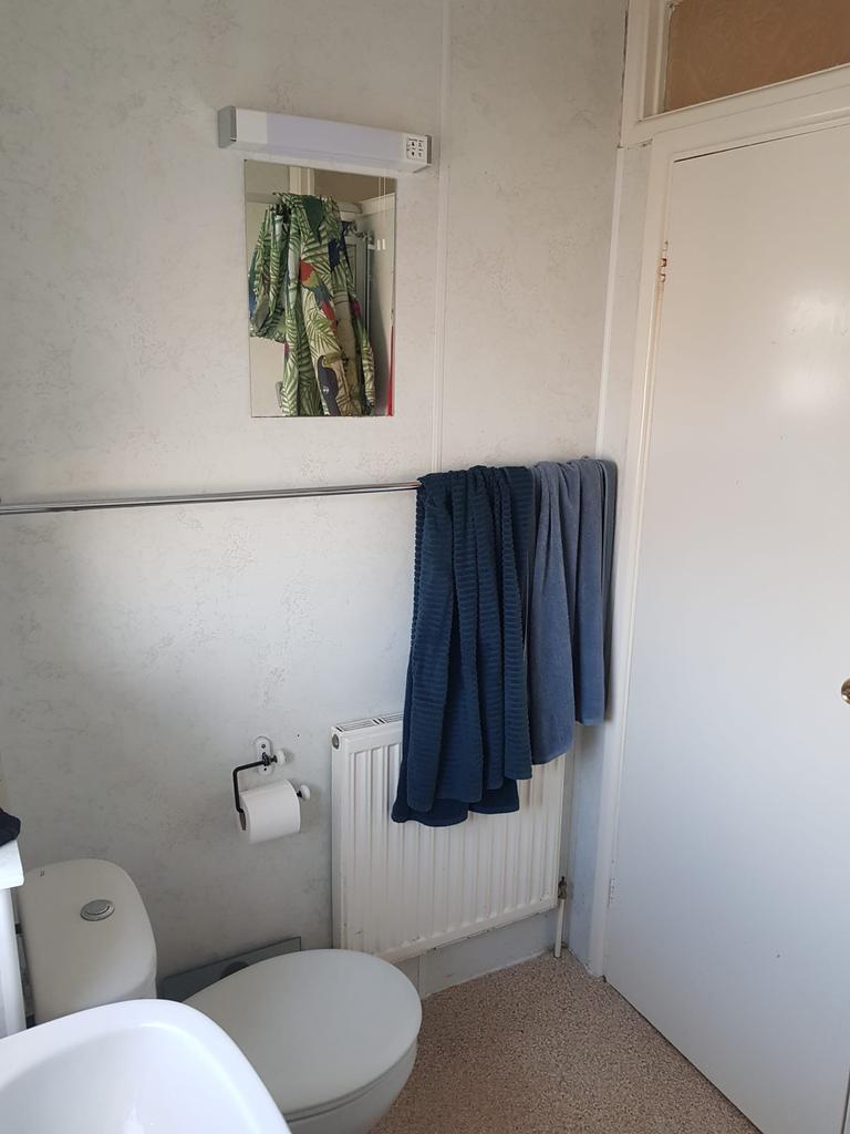 Compact bathroom with tidy fixtures, a wall-mou...