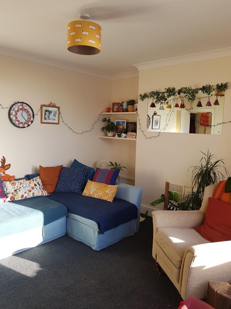 Bright, cosy living room with a comfortable lig...