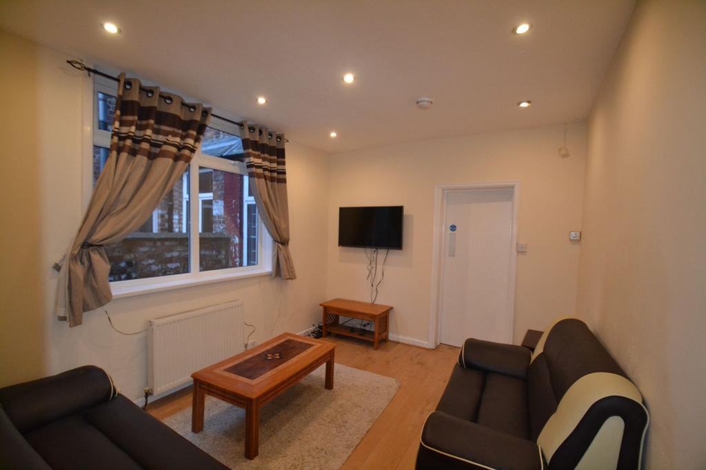 A bright and welcoming living room featuring tw...