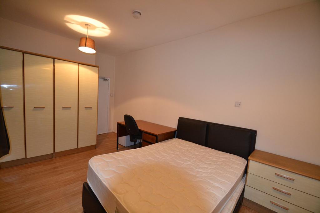 A well-maintained bedroom featuring a comfortab...