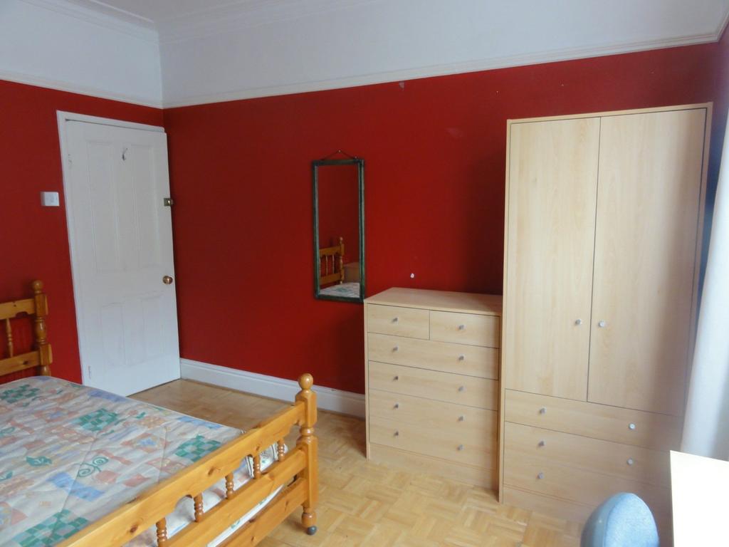 Bright and welcoming double bedroom featuring a...