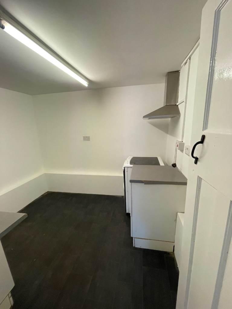 Simple, clean kitchen with worktops and extract...