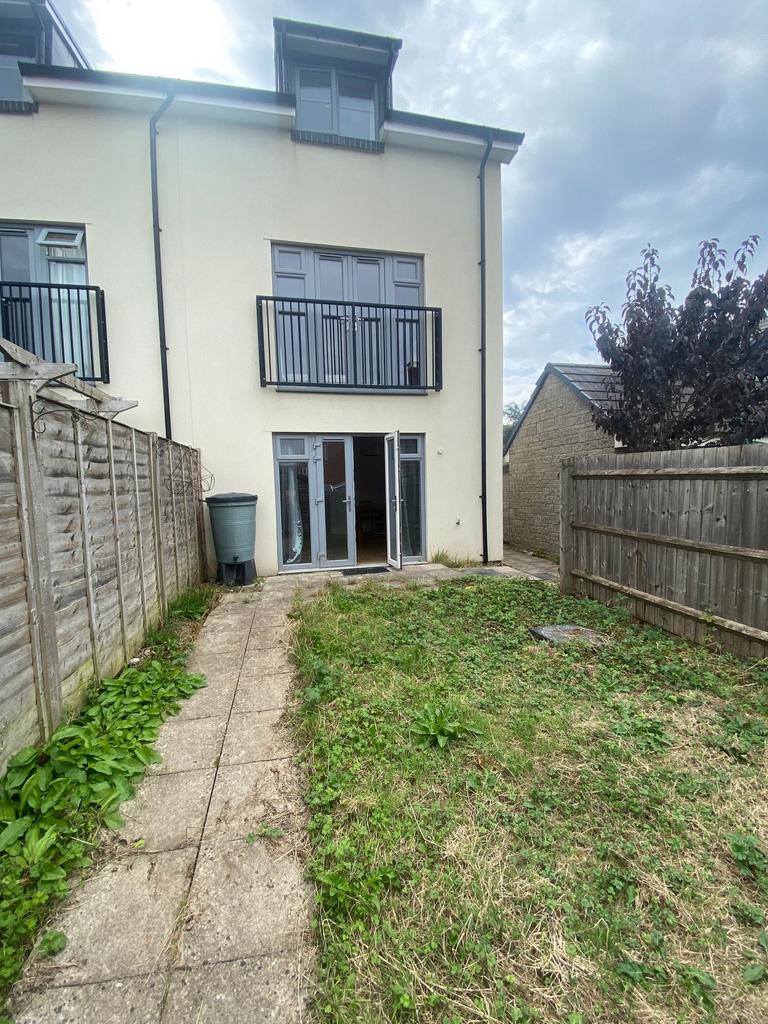 Rear exterior view with a paved path leading to...