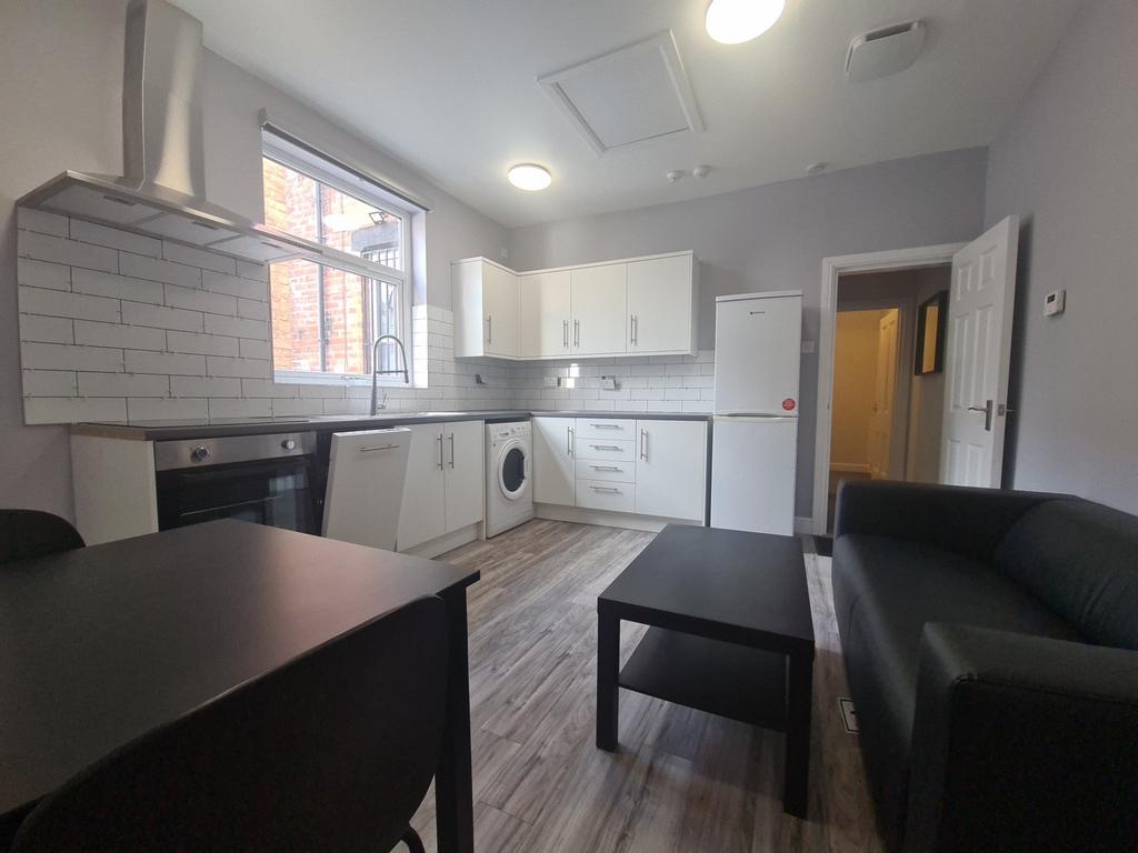 Bright open-plan living area with kitchenette...