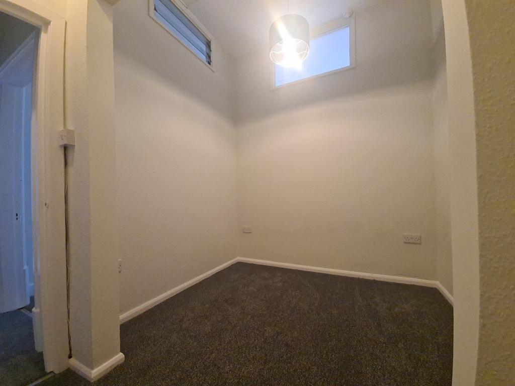 Small tidy room with neutral decor and high win...